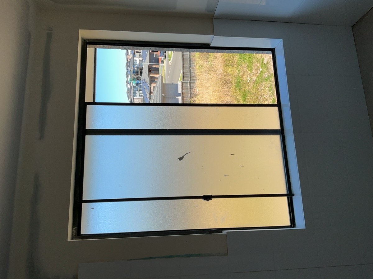 Opening restriction required to a first floor window, recorded during a fixing stage inspection in Austral
